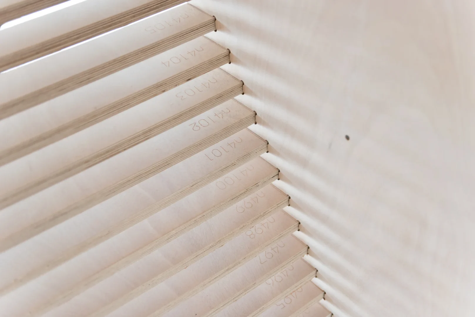 Wooden slats with printed numbers feature in the ODP Architecture & Design Headquarters structure