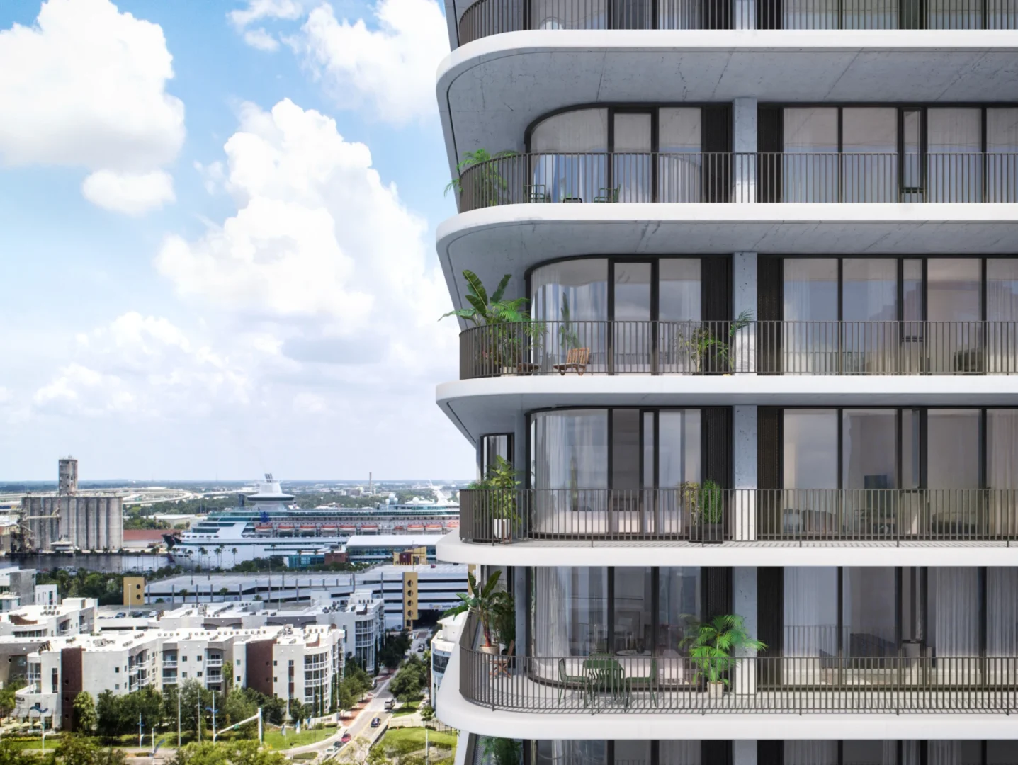 Los balcones de varias plantas de Cora Water Street, en Tampa, ofrecen vistas a un puerto con un crucero y un paisaje urbano bajo un cielo nublado.