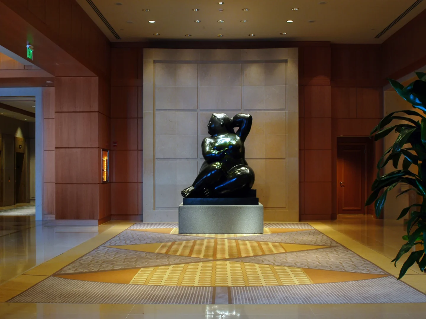 A glossy black sculpture sits on a pedestal in the Naples Beach Four Seasons Resort & Residences lobby
