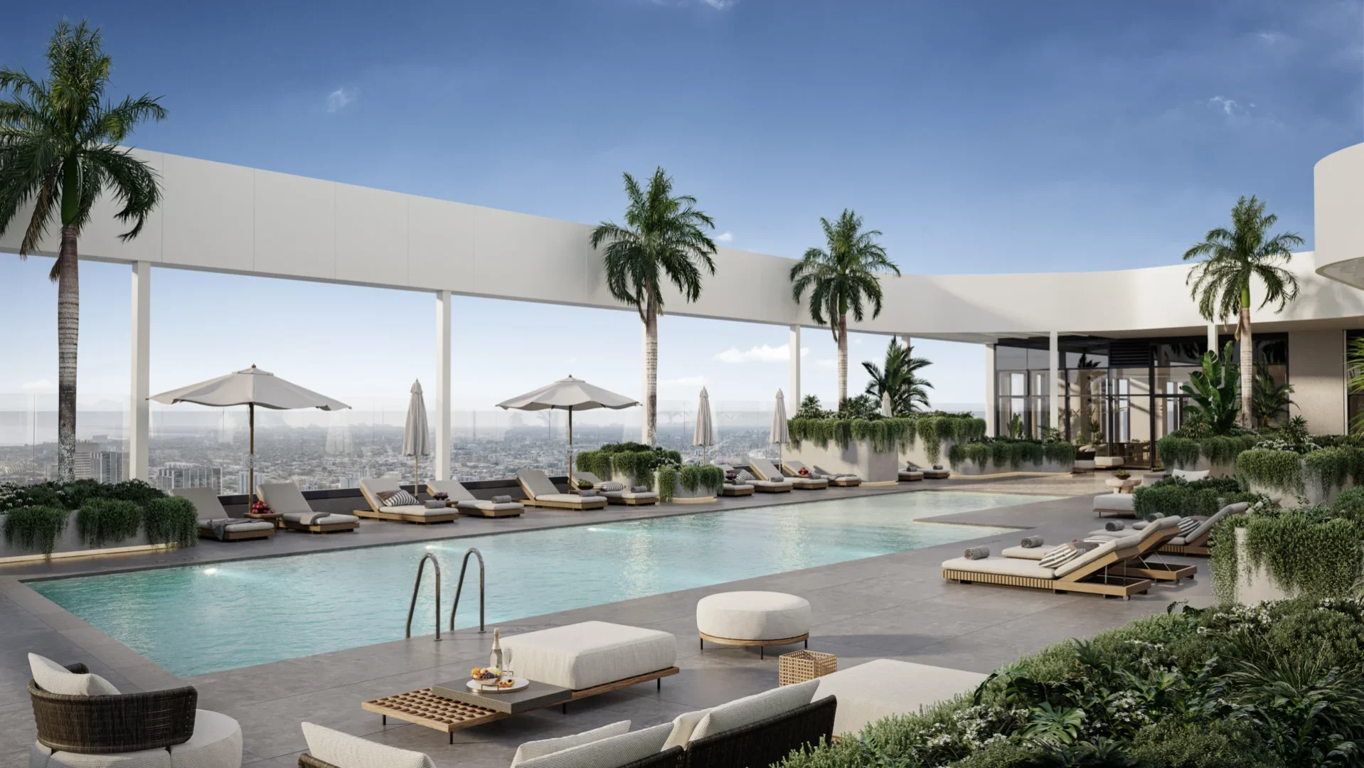 A swimming pool with lounge chairs and umbrellas sits on the HUB Miami terrace among palm trees and a city skyline