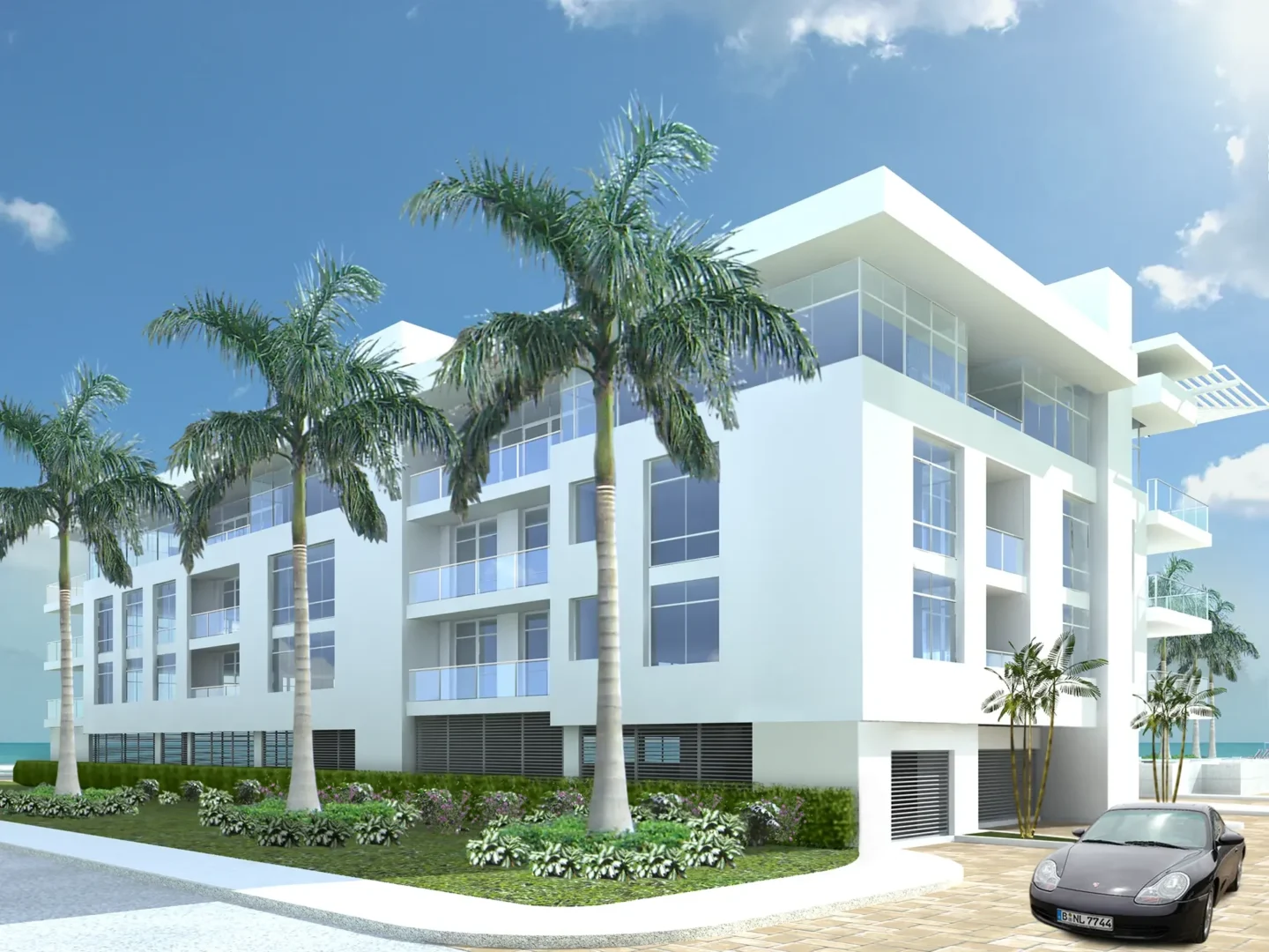 El edificio de apartamentos «White Ice», con balcones, se alza detrás de unas altas palmeras, junto a un coche aparcado.