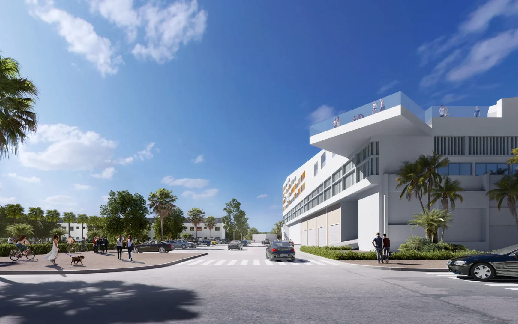 A white Kimco Agora building with a rooftop terrace and people is adjacent to a street with cars and pedestrians