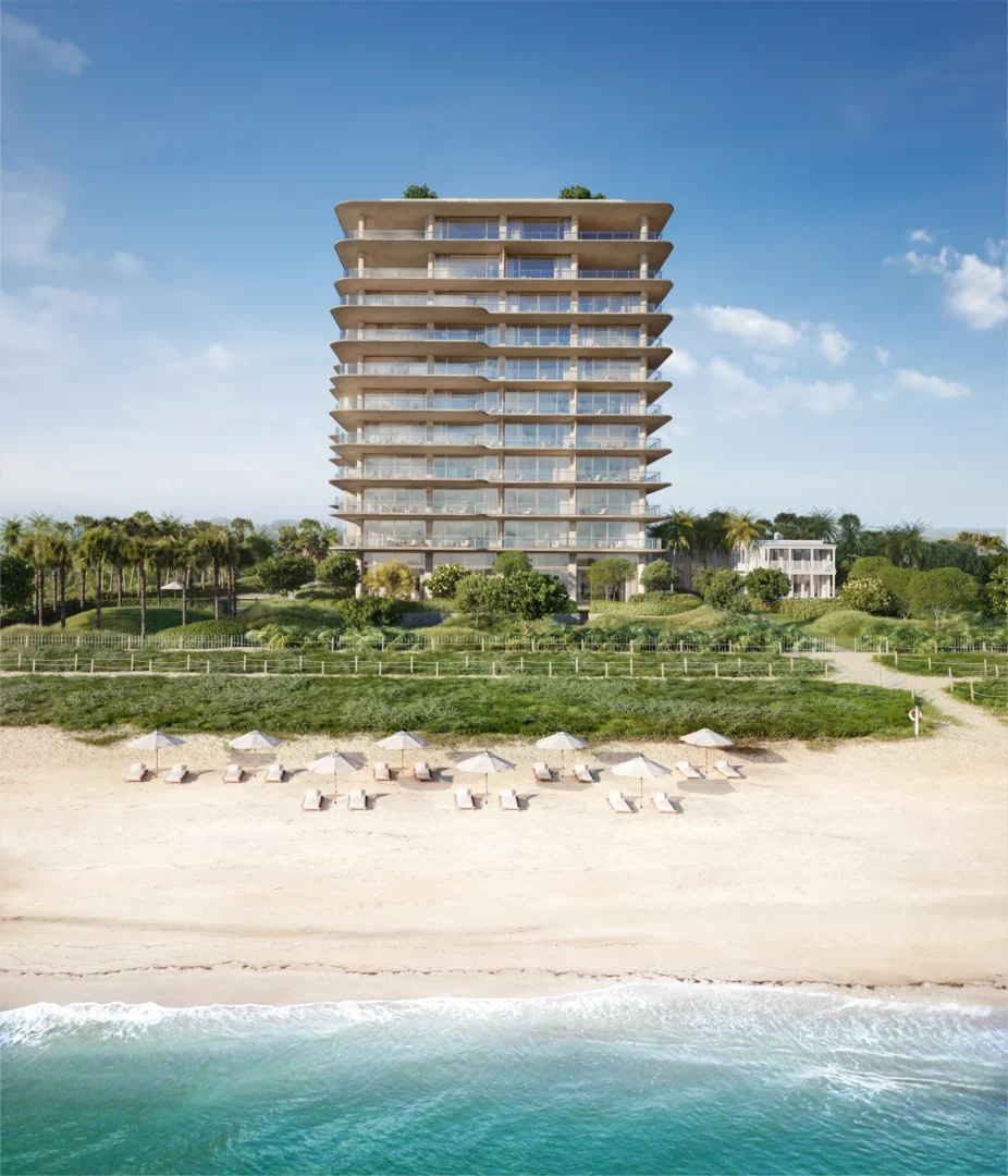 A multi-story building from Surfside Seaway stands behind a sandy beach with umbrellas and turquoise ocean waves