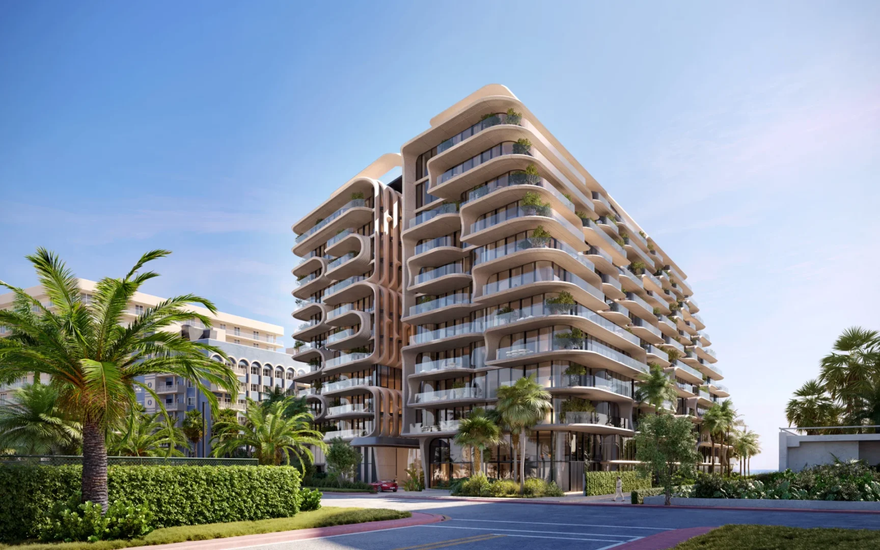A multi-story apartment building with numerous balconies and terraces from The Delmore stands among palm trees and greenery