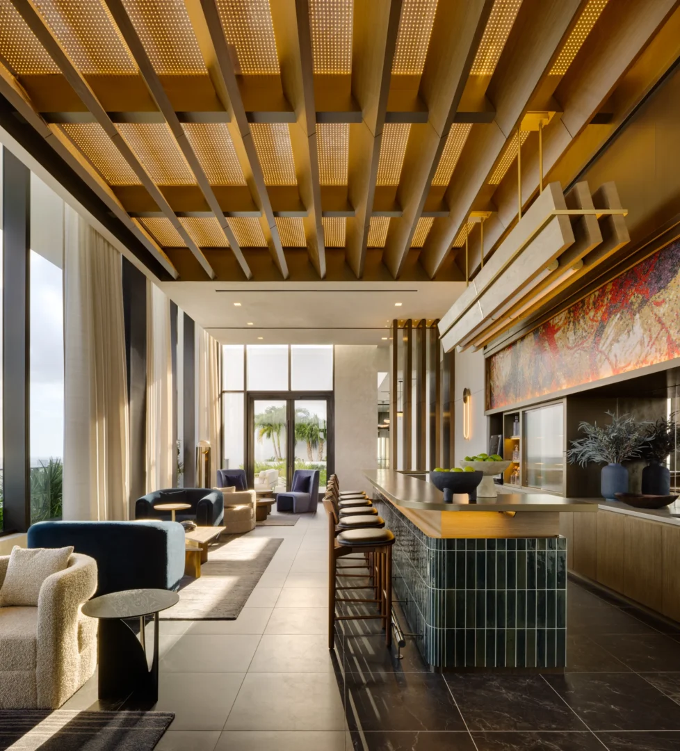 A backlit, coffered wooden ceiling spans the bar and lounge area in the Forma project