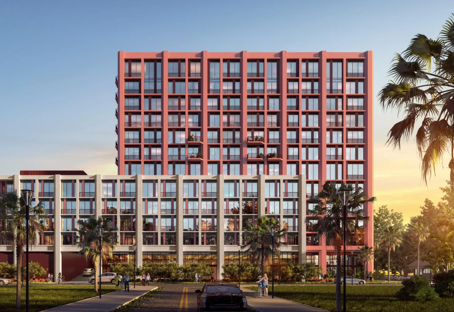 A large salmon-colored building in Little River features balconies and windows near a street with palm trees and pedestrians