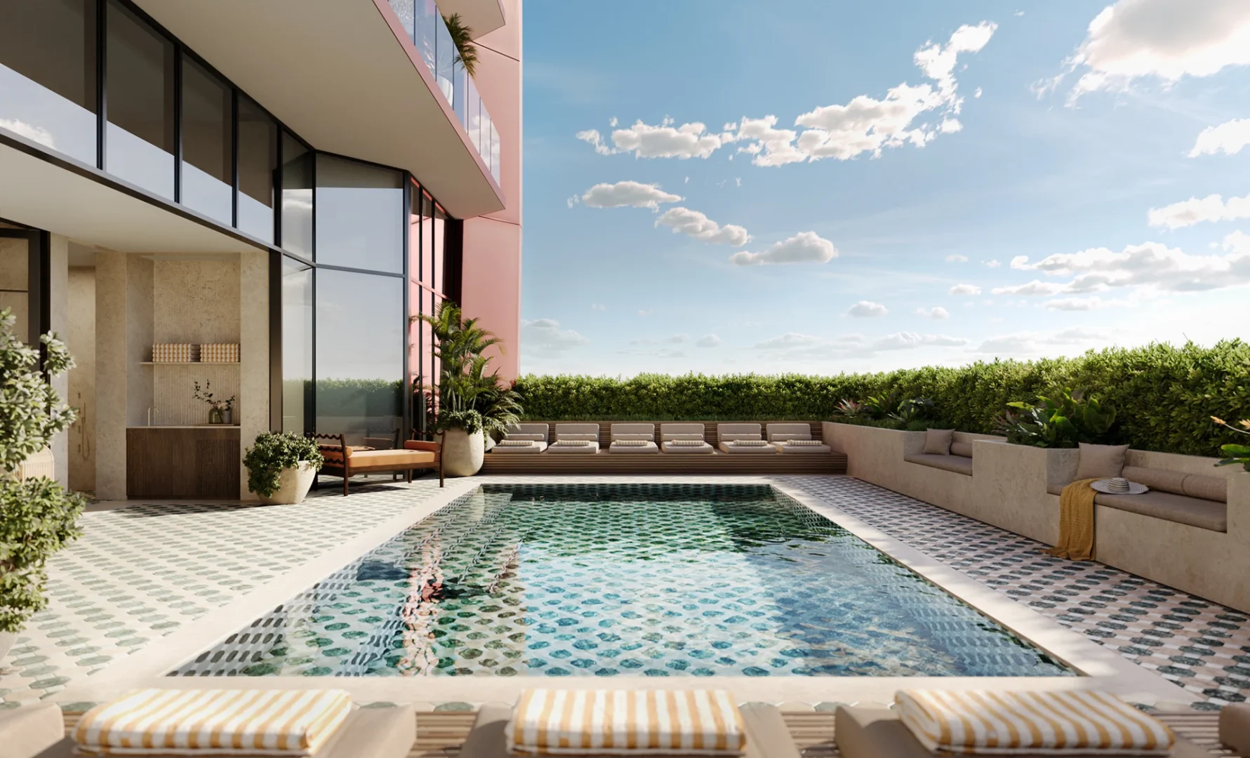 A rectangular swimming pool on a tiled terrace at Villa Miami is surrounded by sun loungers and a glass-walled building