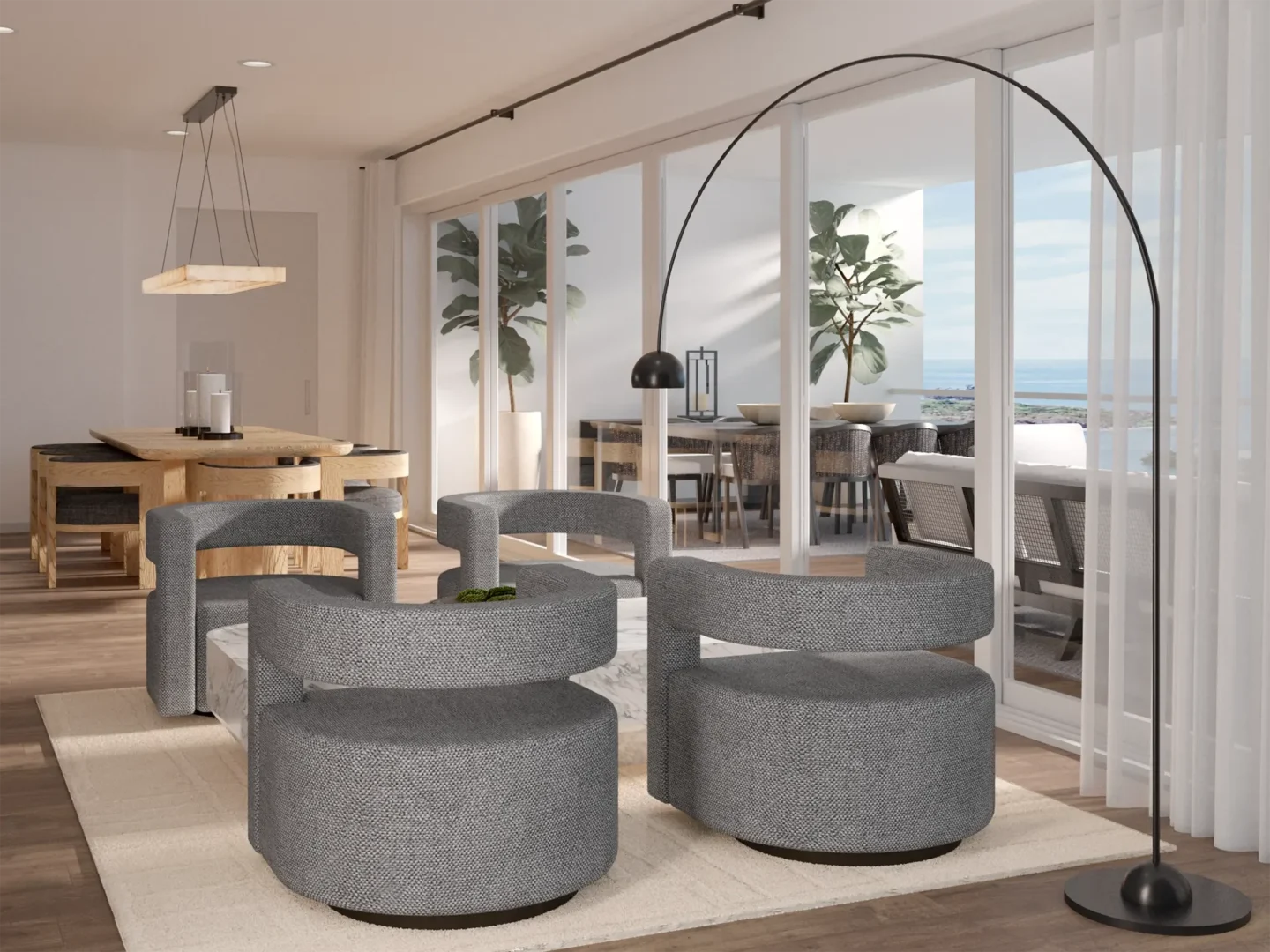 Grey armchairs and a black arched lamp are in the Coastal Sanctuary dining area near a glass terrace door