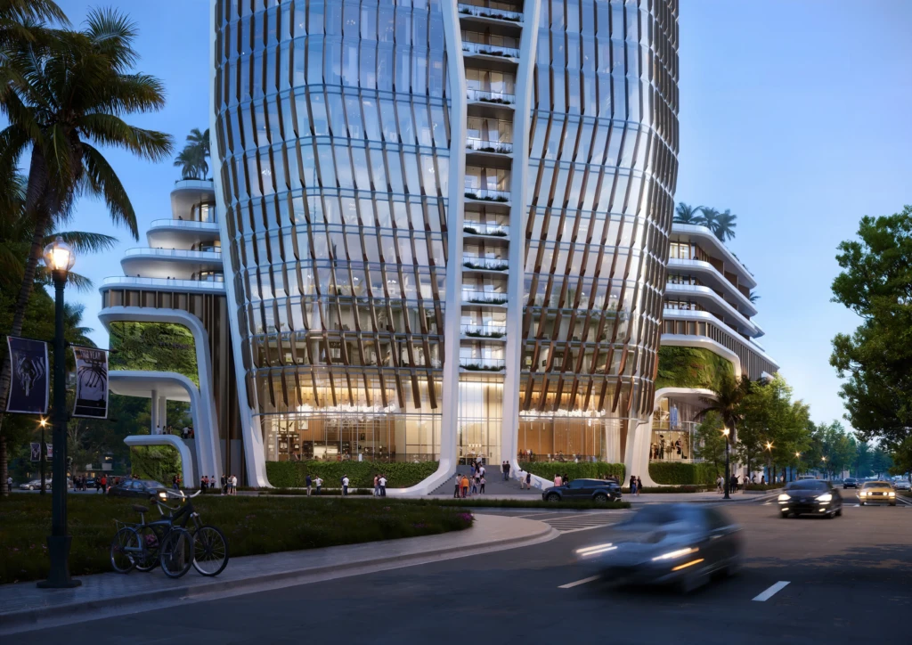 Un edificio alto de cristal de «Isles Of Dreams» cuenta con zonas verdes en terrazas y gente paseando cerca de una calle por la que circulan coches.